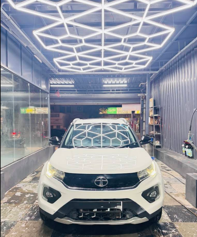 White Tata vehicle finished inside Magic Car Spa studio under geometric ceiling lights